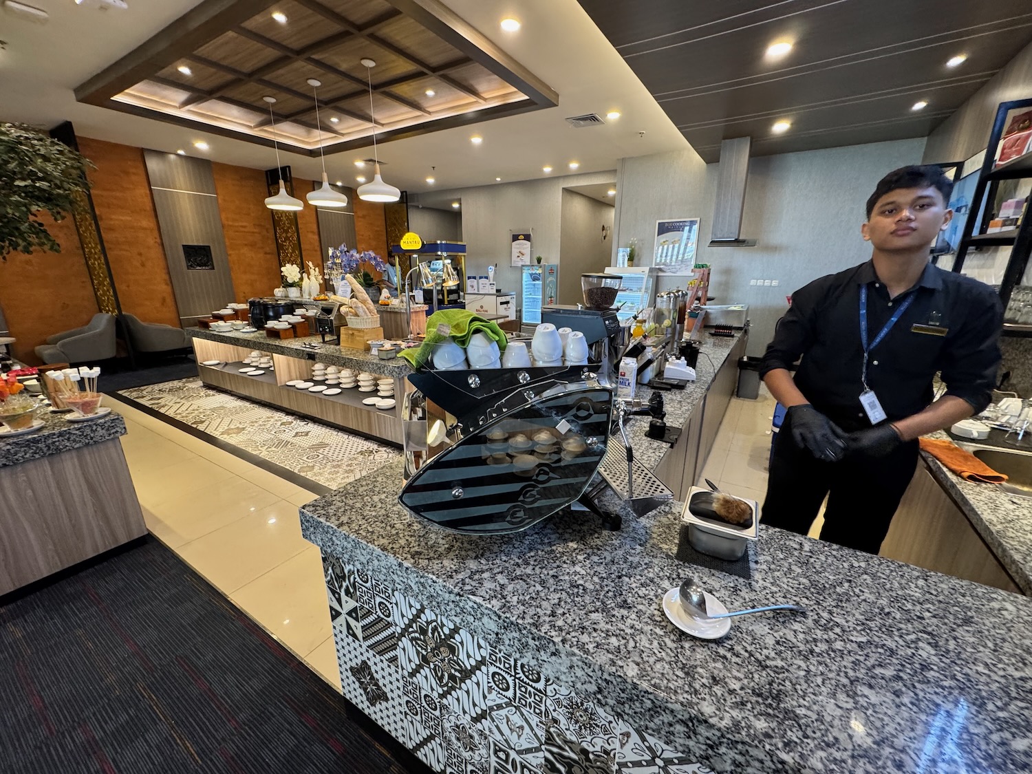a man standing behind a counter in a restaurant