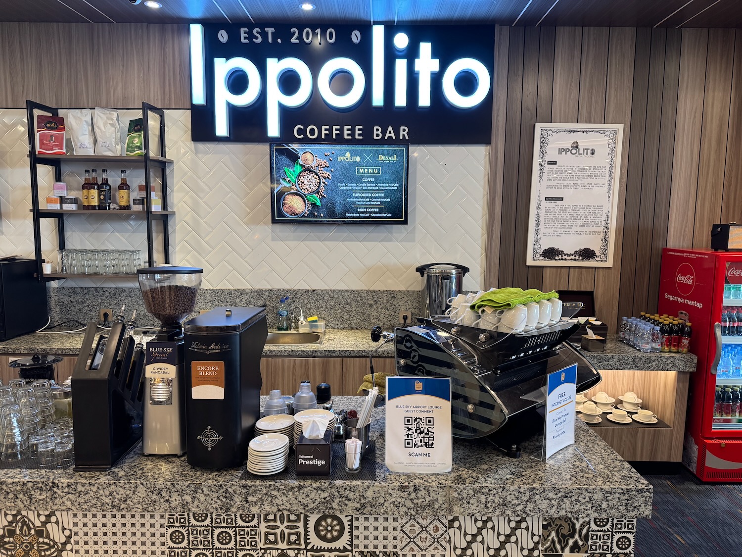 a counter with a coffee machine and a sign