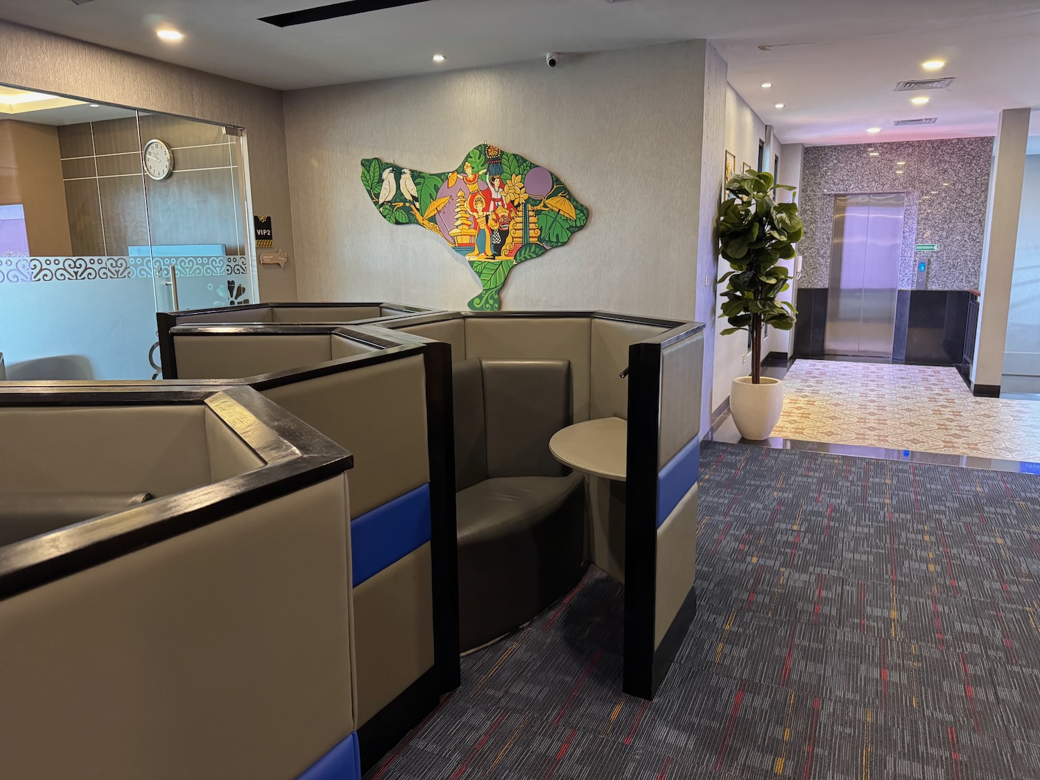 a room with a booth and a wall art