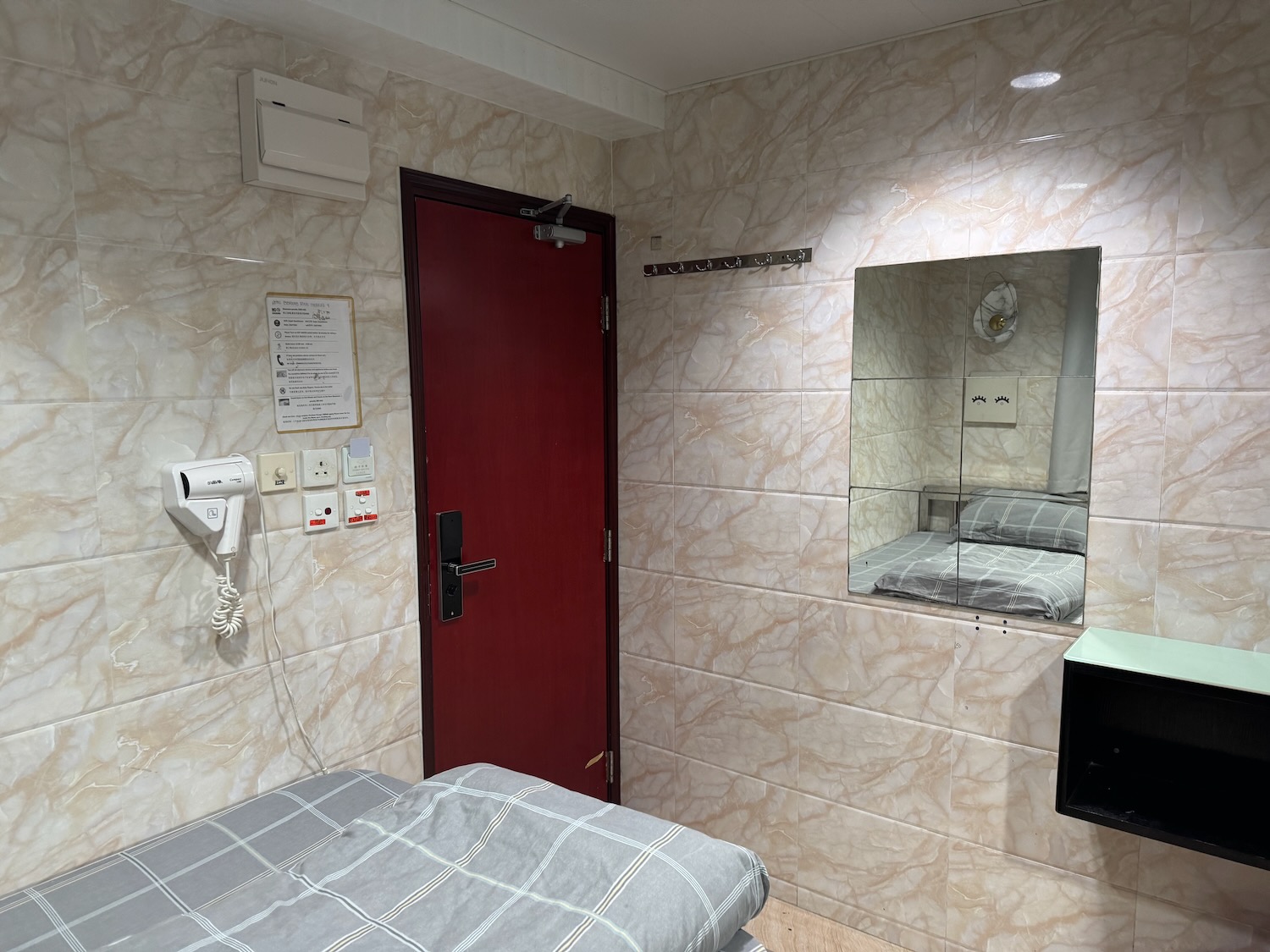 a room with a red door and a mirror