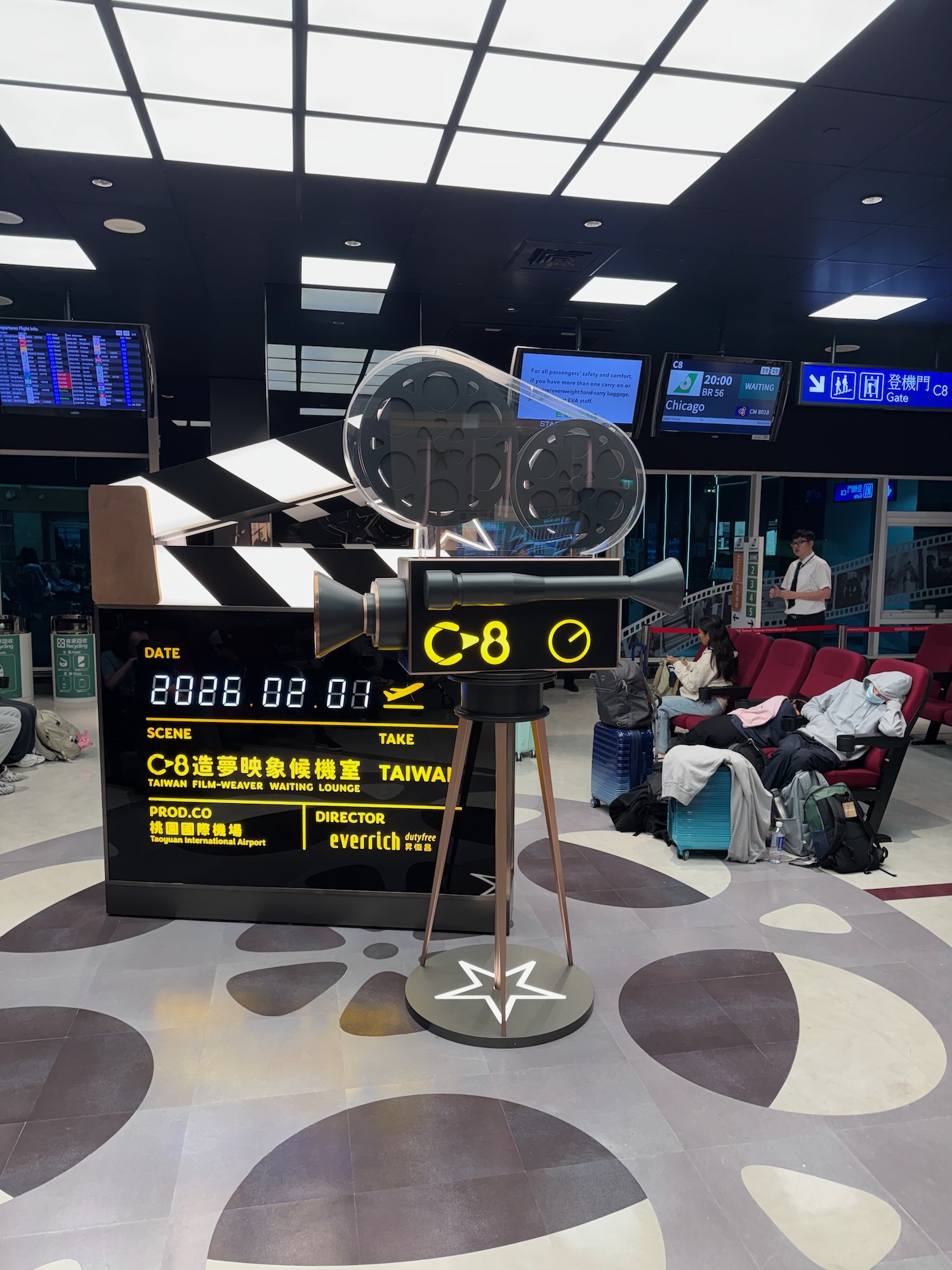 a movie camera and a sign in a airport