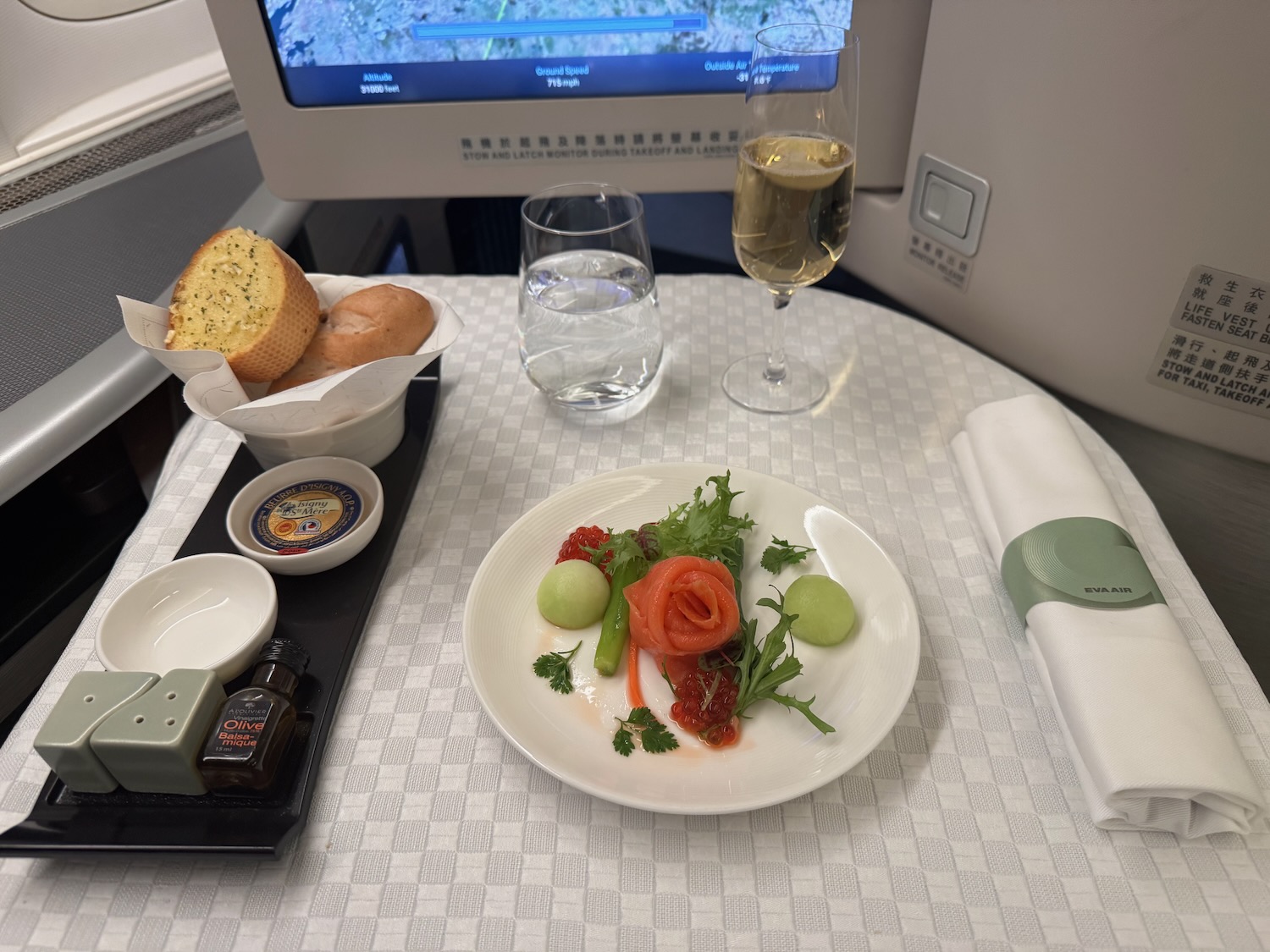 a plate of food and a glass of wine on a table