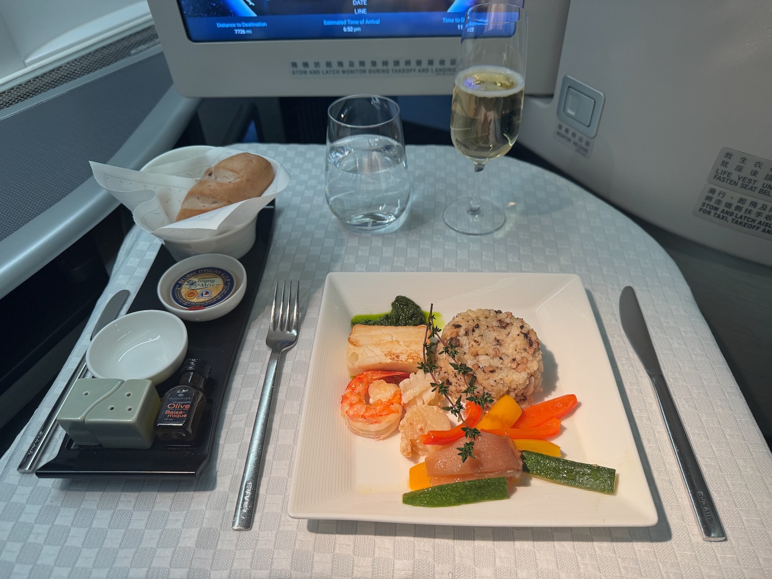 a plate of food and a glass of wine on a table