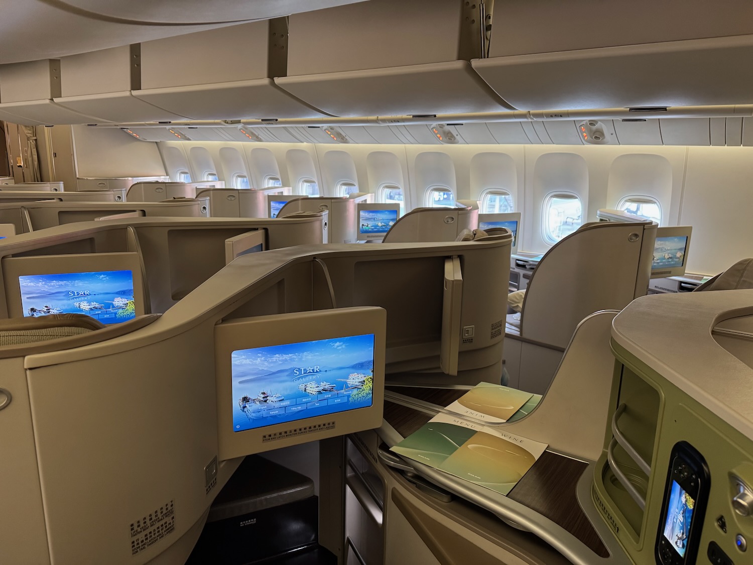 a room with rows of seats and monitors
