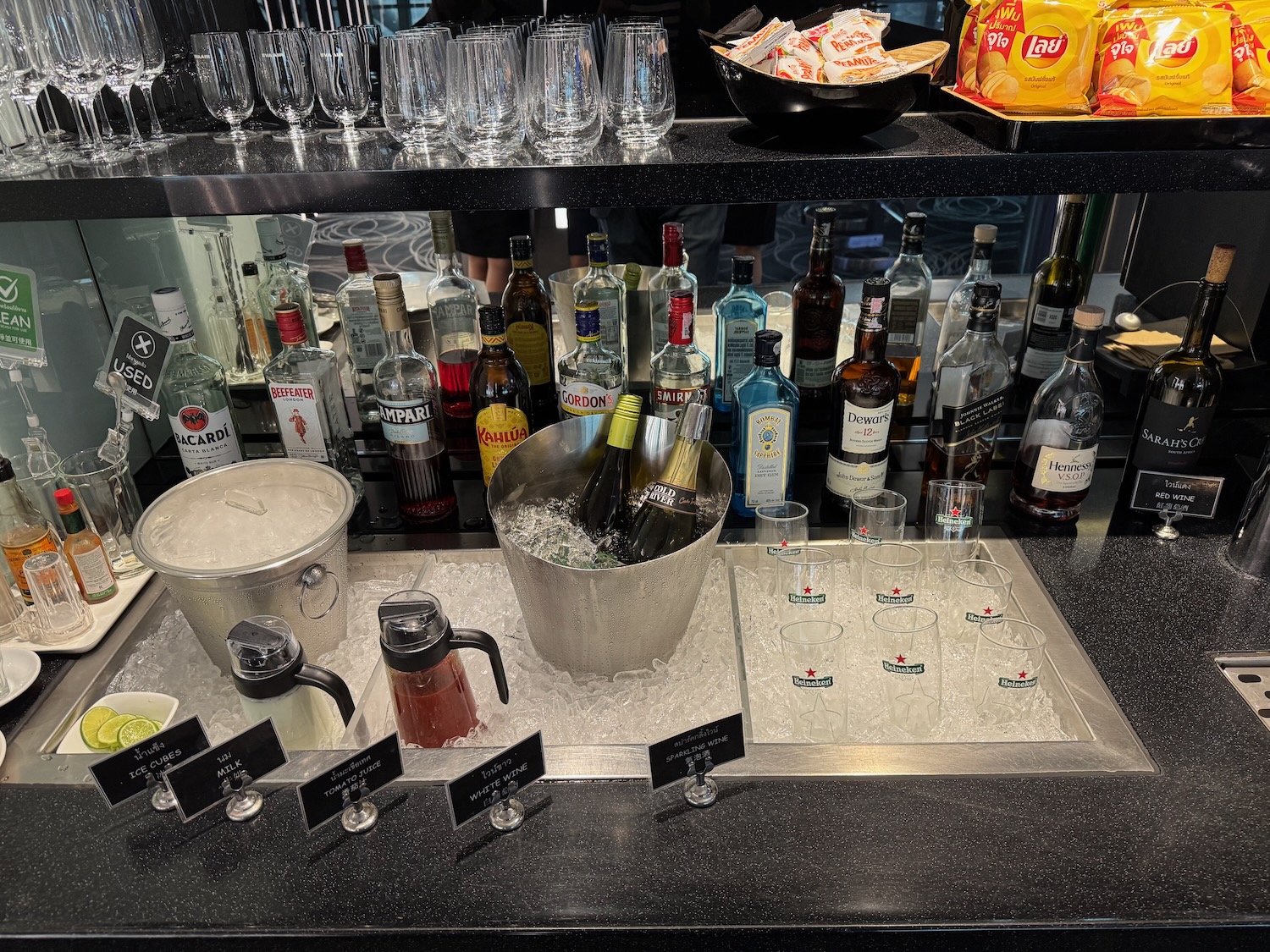 a shelf with bottles and glasses on it