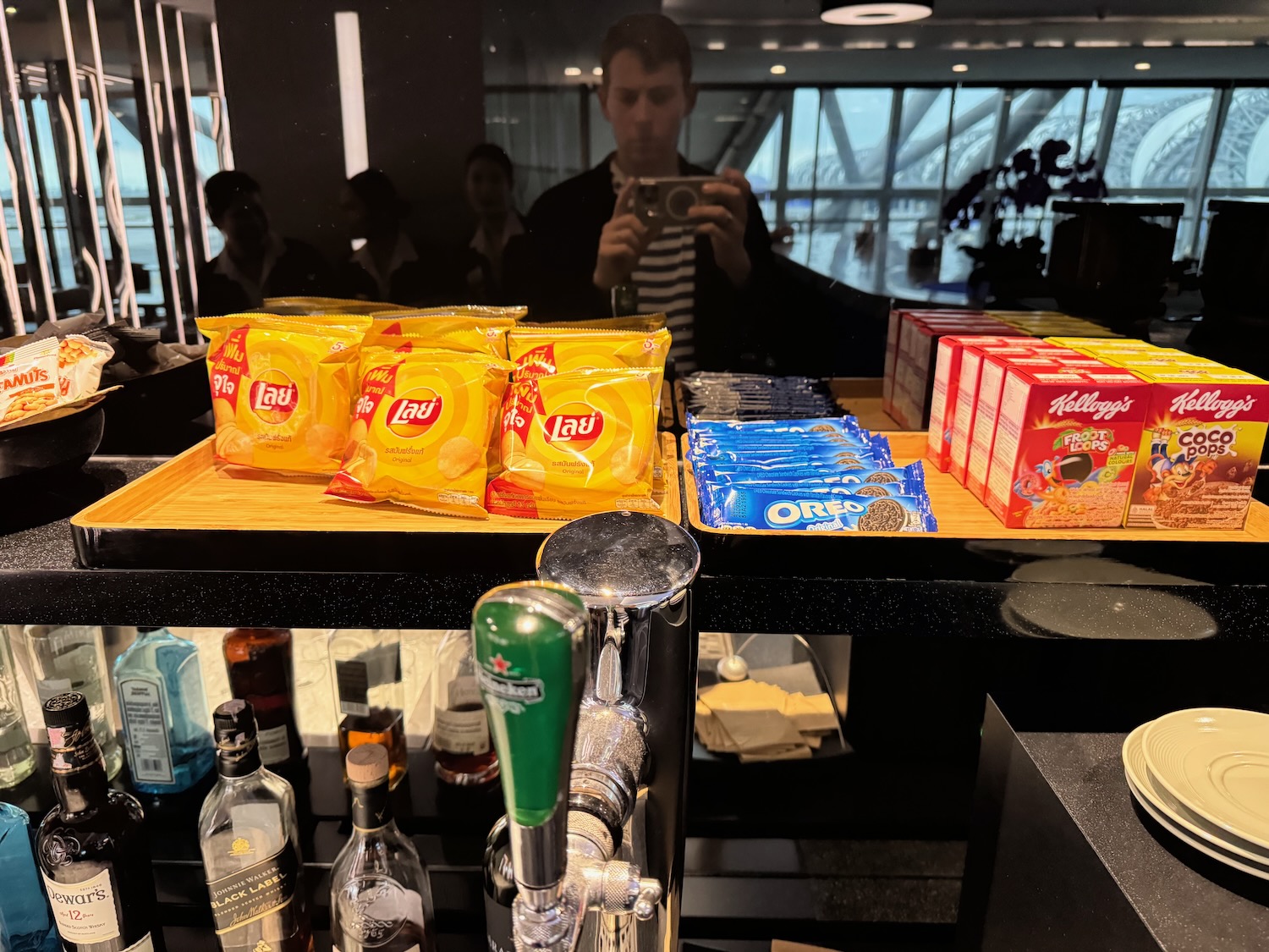 a group of people taking a picture of a man taking a picture of snacks