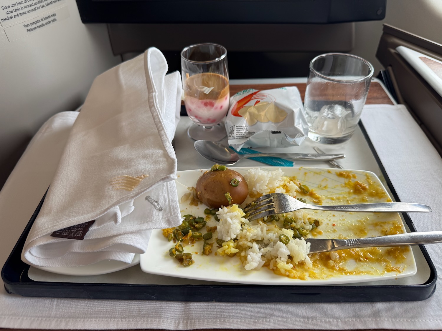 a plate with food on it and a napkin on a tray