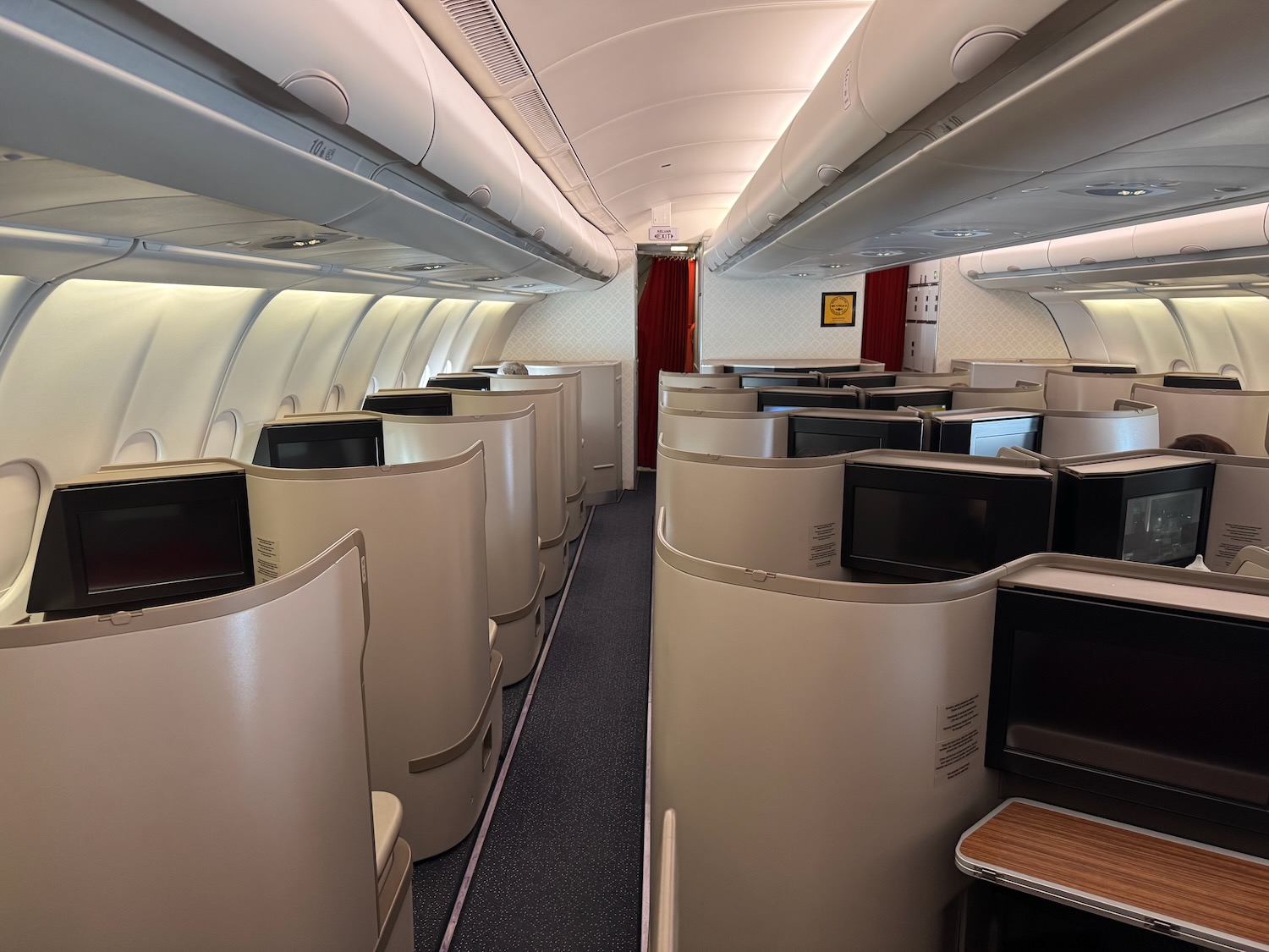 a row of seats with tvs on the side