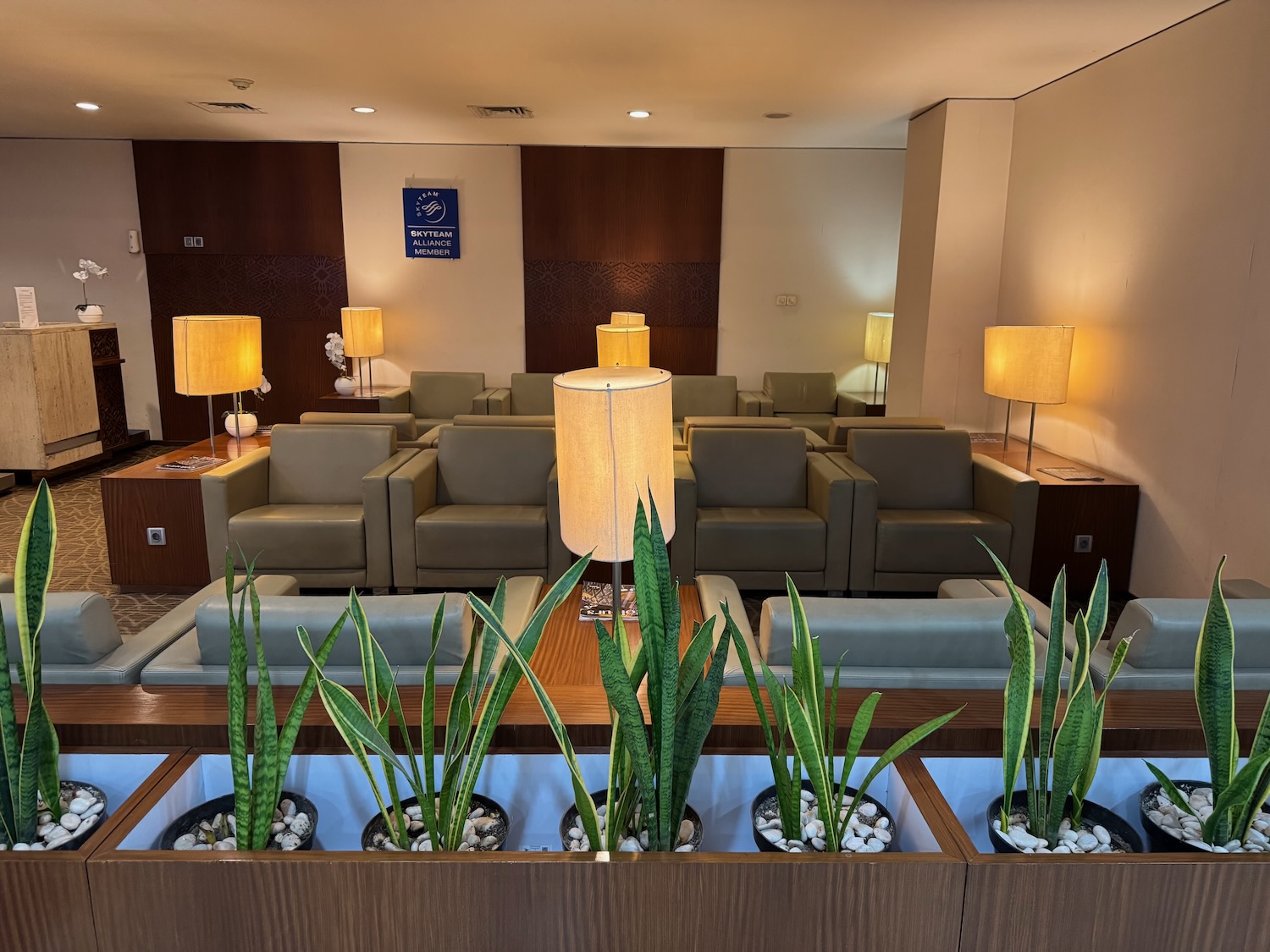 a room with couches and chairs and a table with lamps