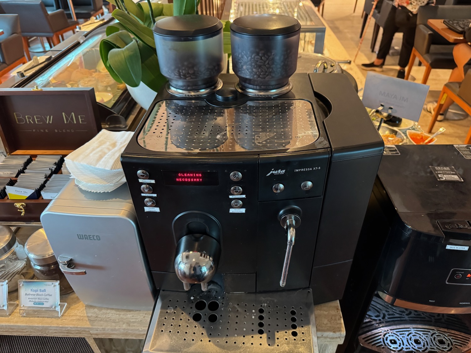 a black machine with two cups on top