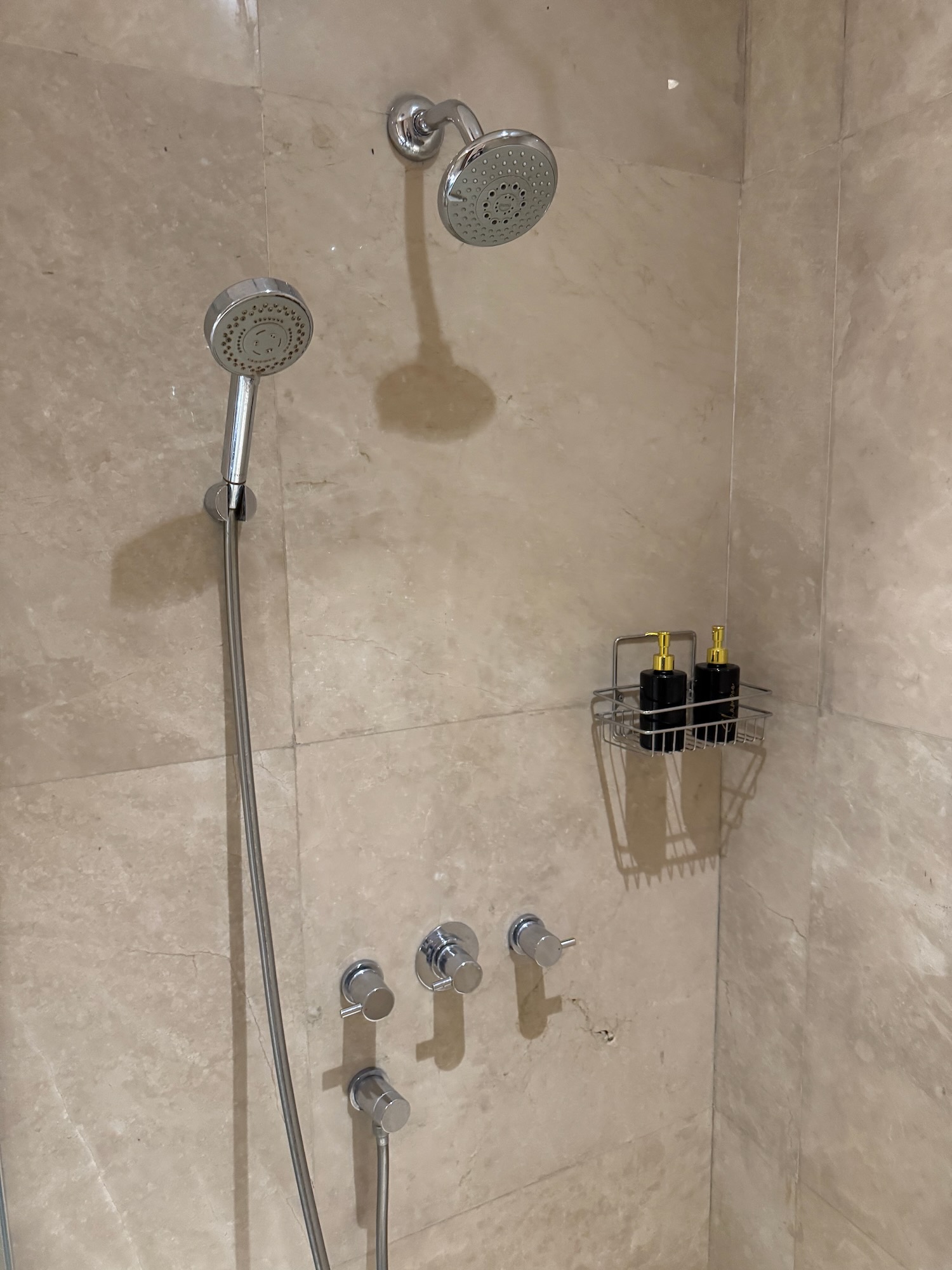 a shower head and faucet in a bathroom