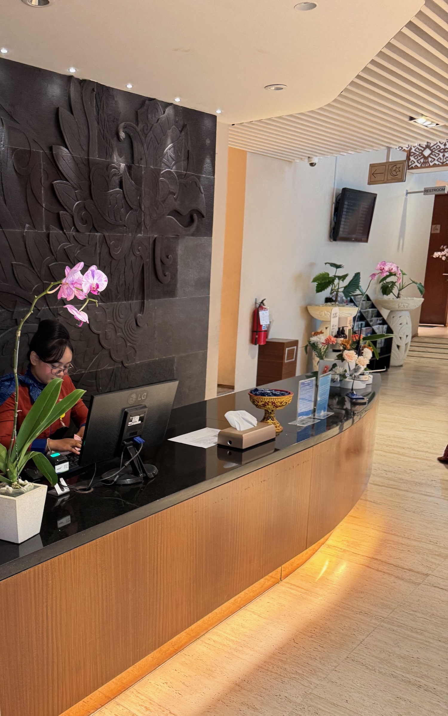 a woman sitting at a desk in a hotel