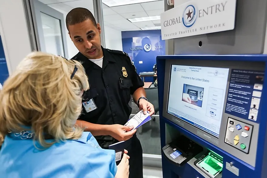 a man in uniform and a woman in front of a machine