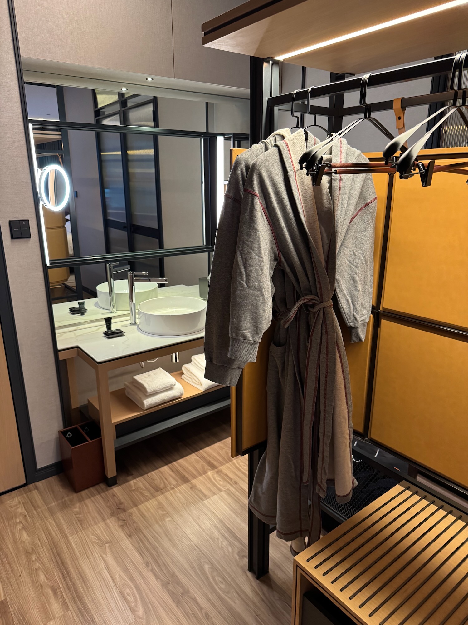 a bathroom with a bathrobe and a sink