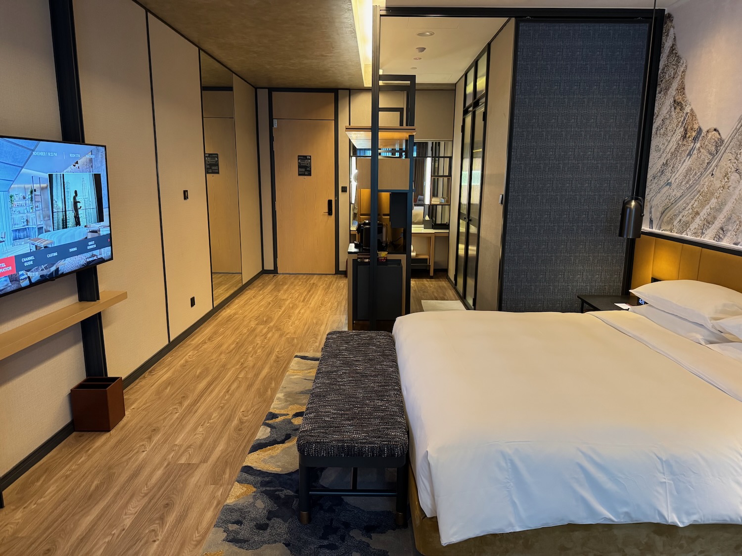 a bedroom with a bed and a television