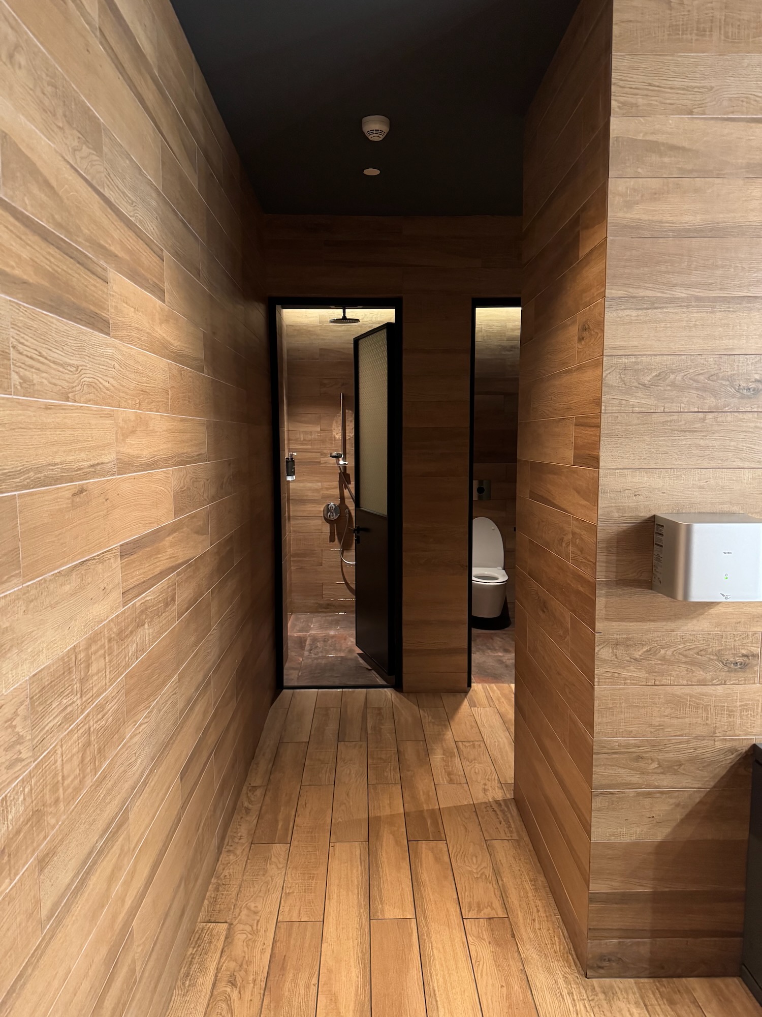 a bathroom with wood walls and a door