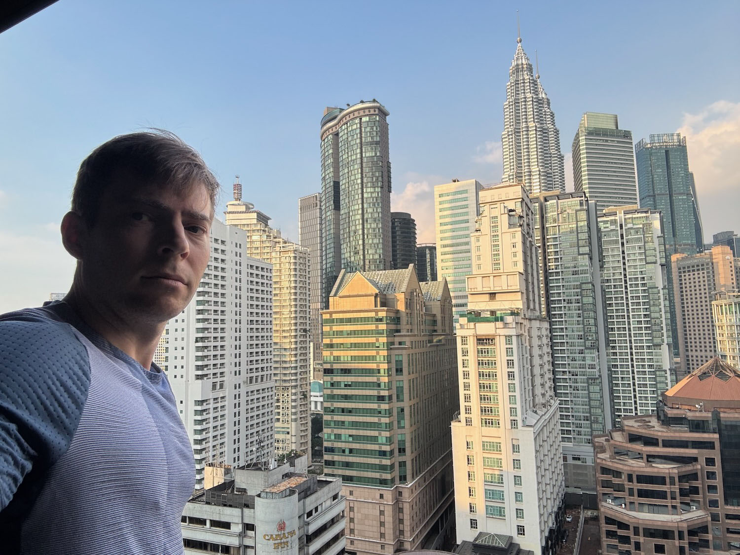 a man taking a selfie in front of a city