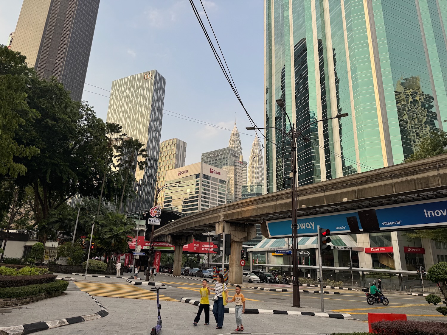 a group of people walking on a street with buildings in the background