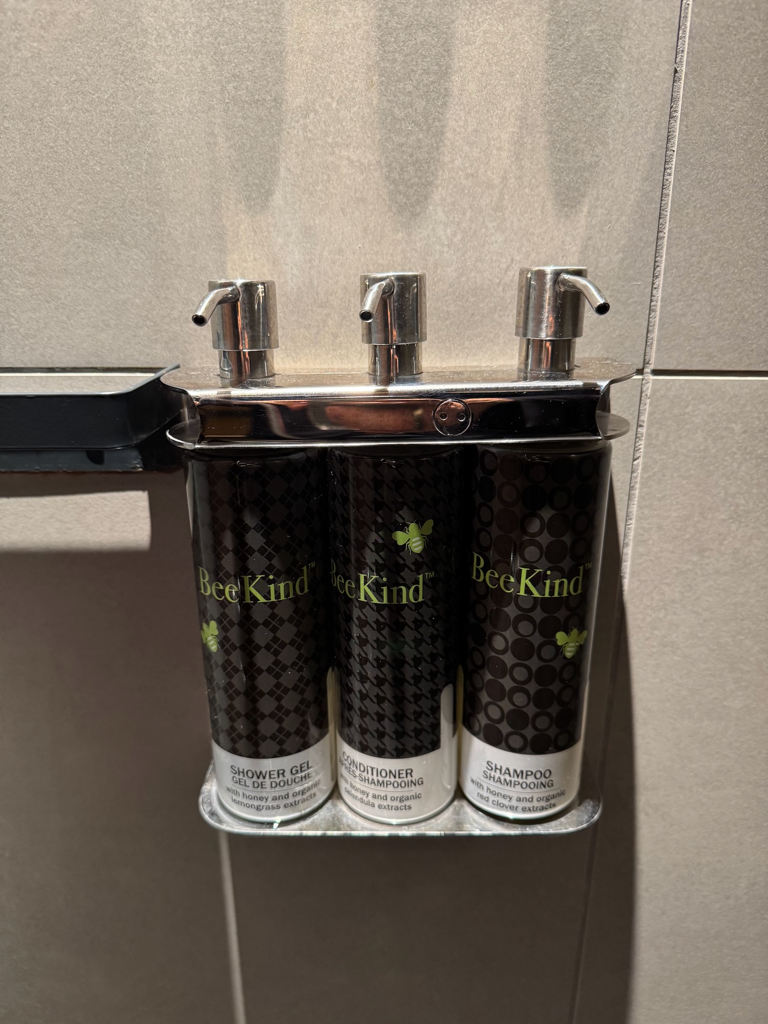 a group of shampoo bottles on a metal shelf