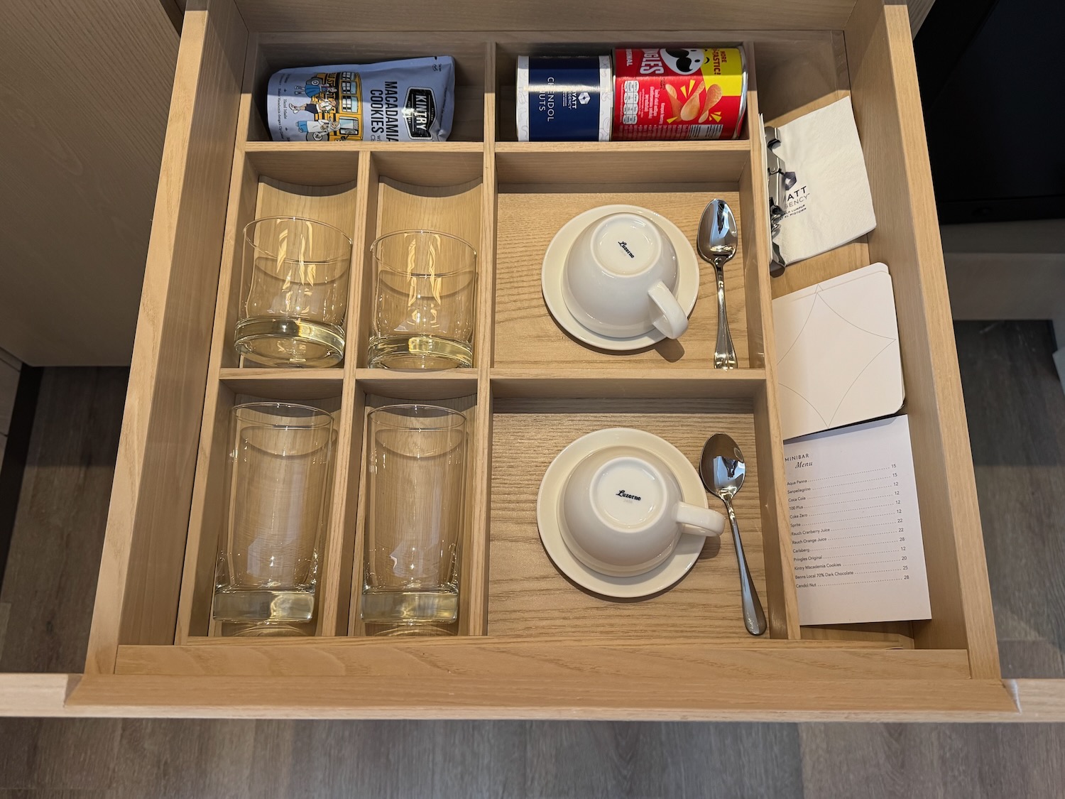 a drawer with a tray of glasses and cups
