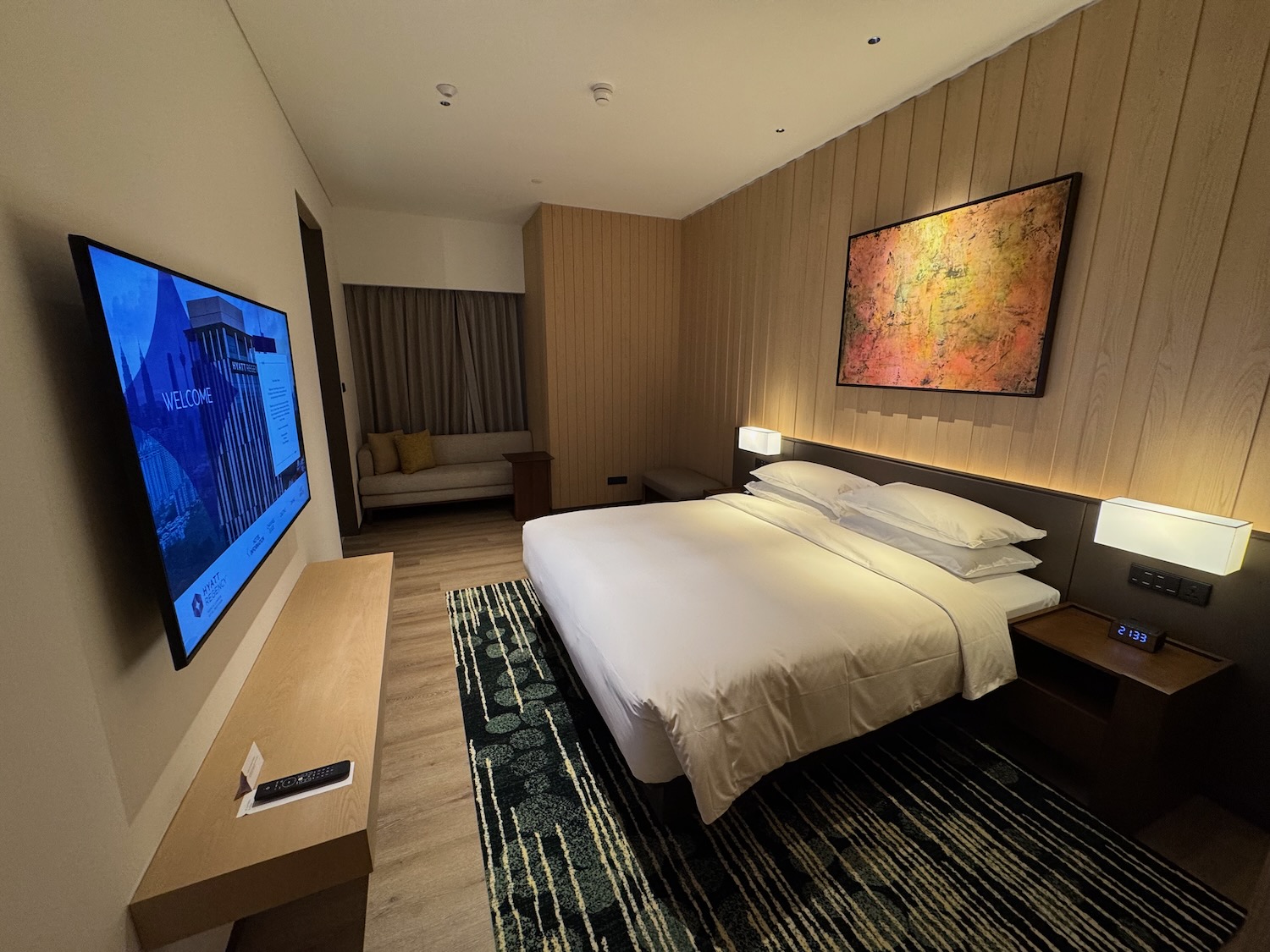 a bedroom with a bed and a television