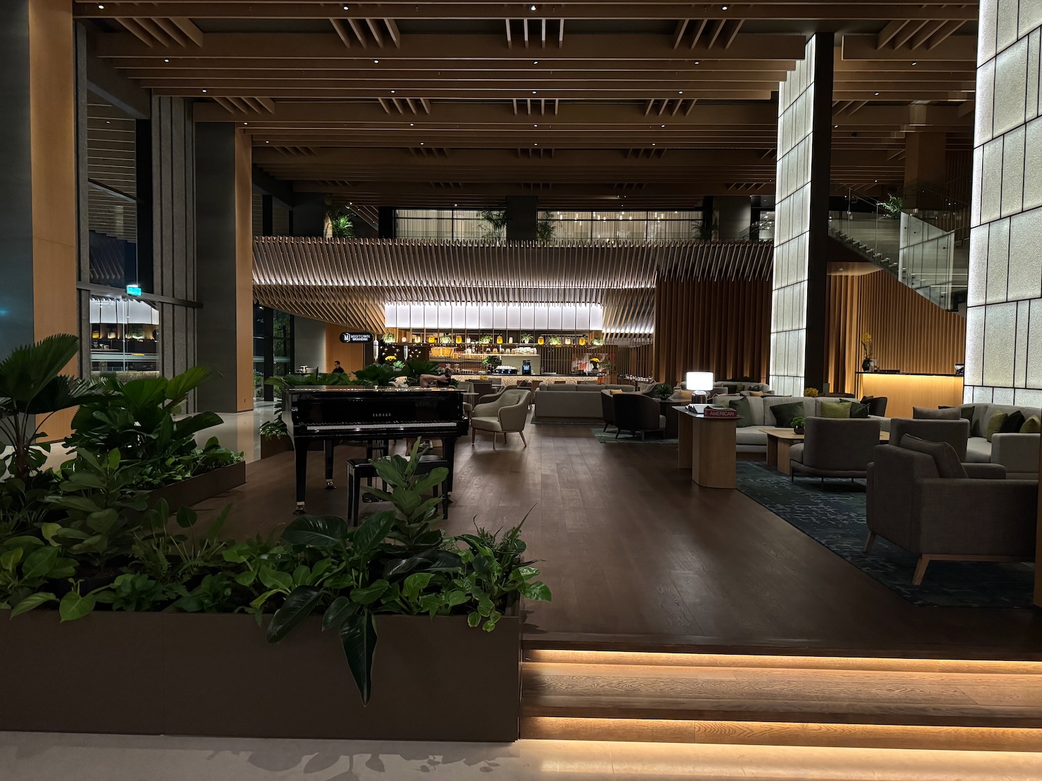 a room with a piano and plants