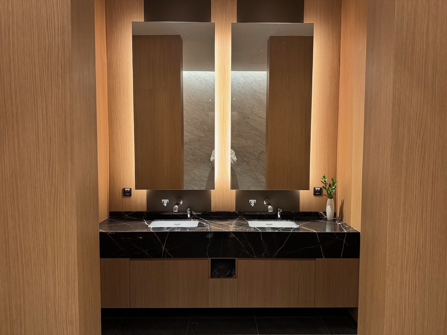 a bathroom with sinks and mirrors