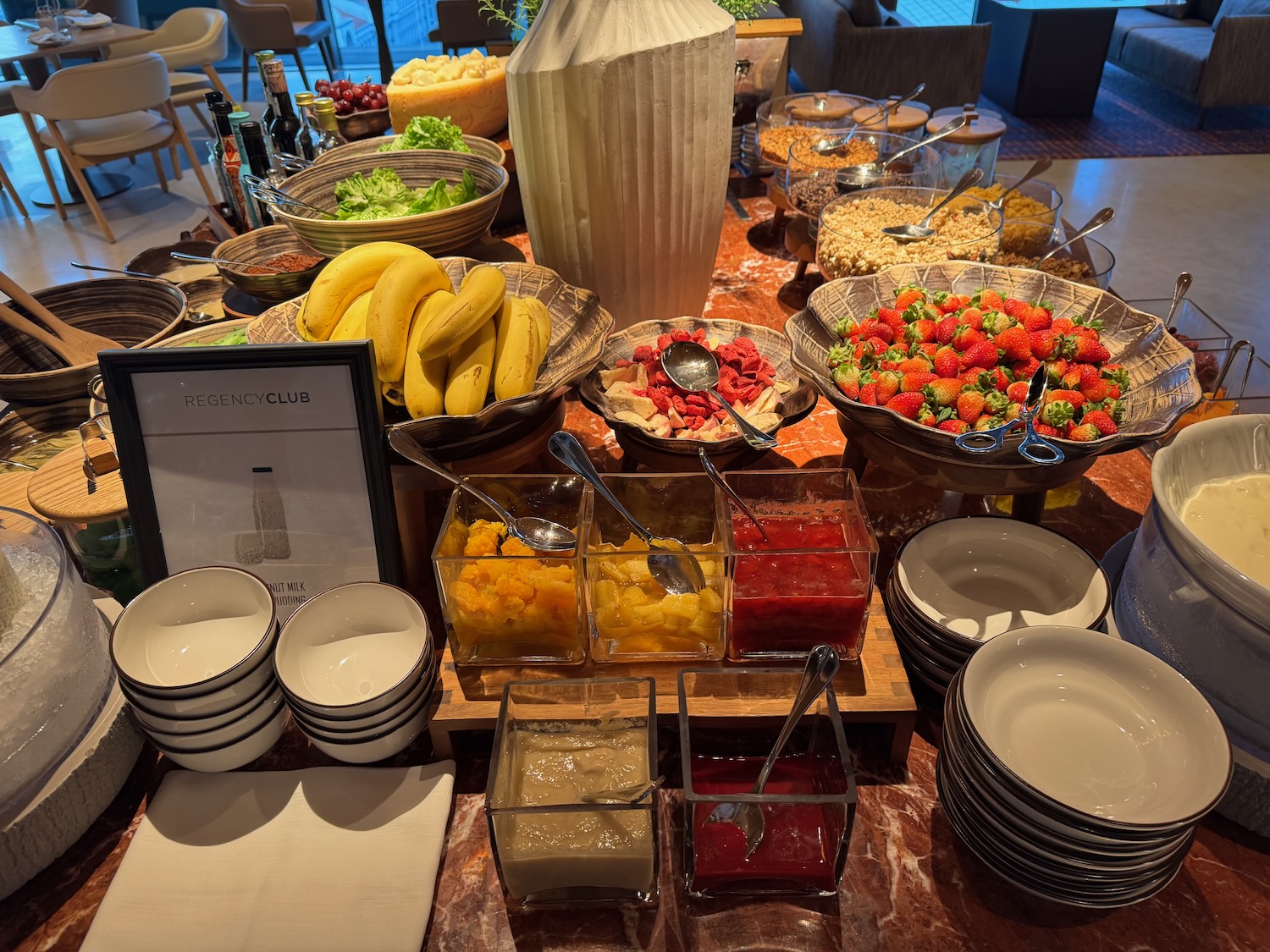 a table with bowls of food and fruit