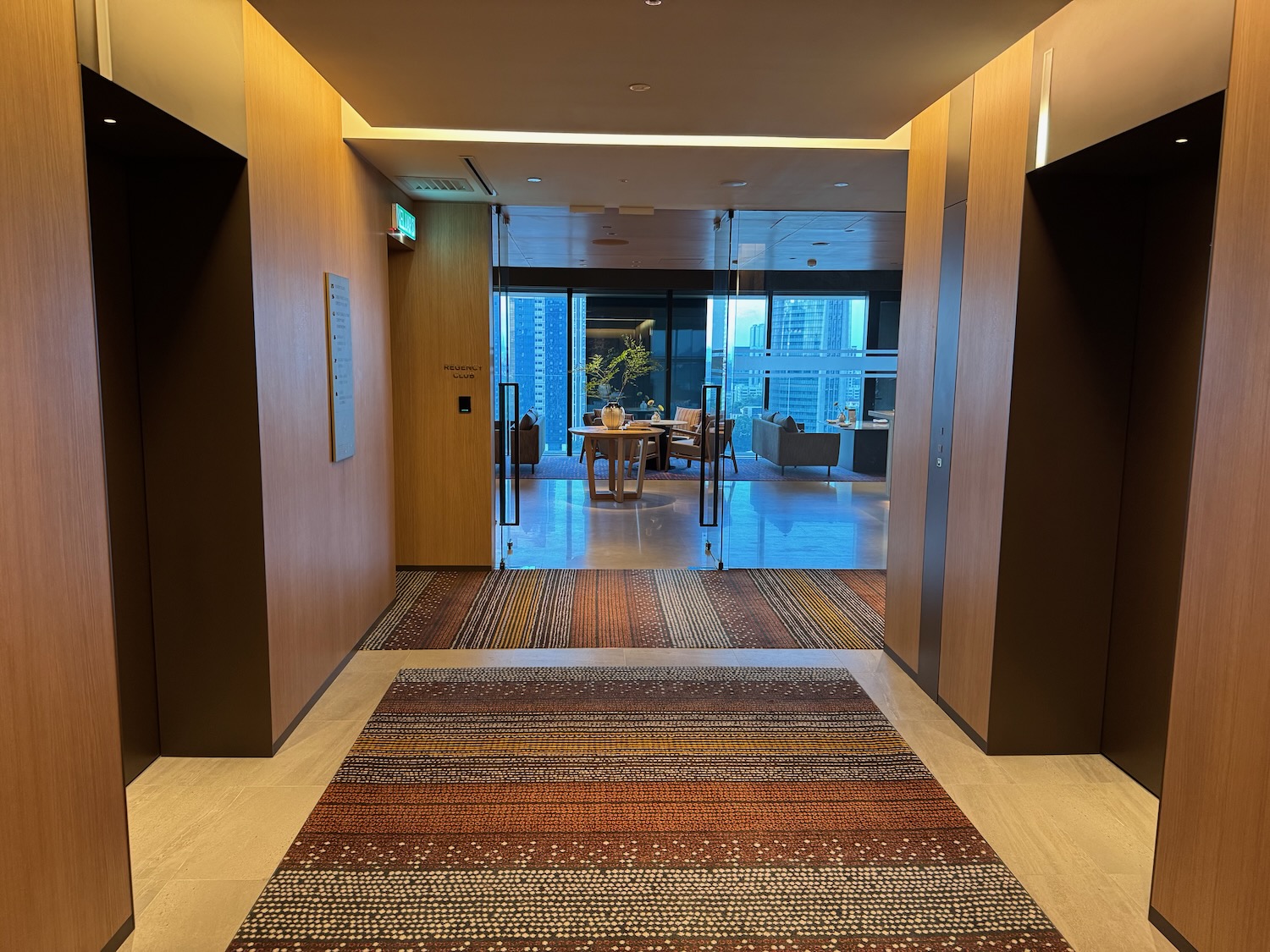 a hallway with a rug and a table