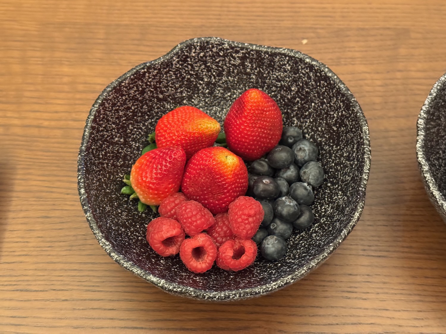 a bowl of fruit on a table