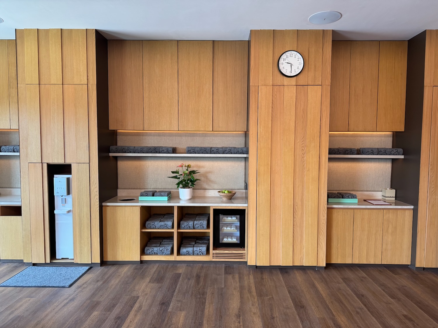 a room with wood cabinets and a clock