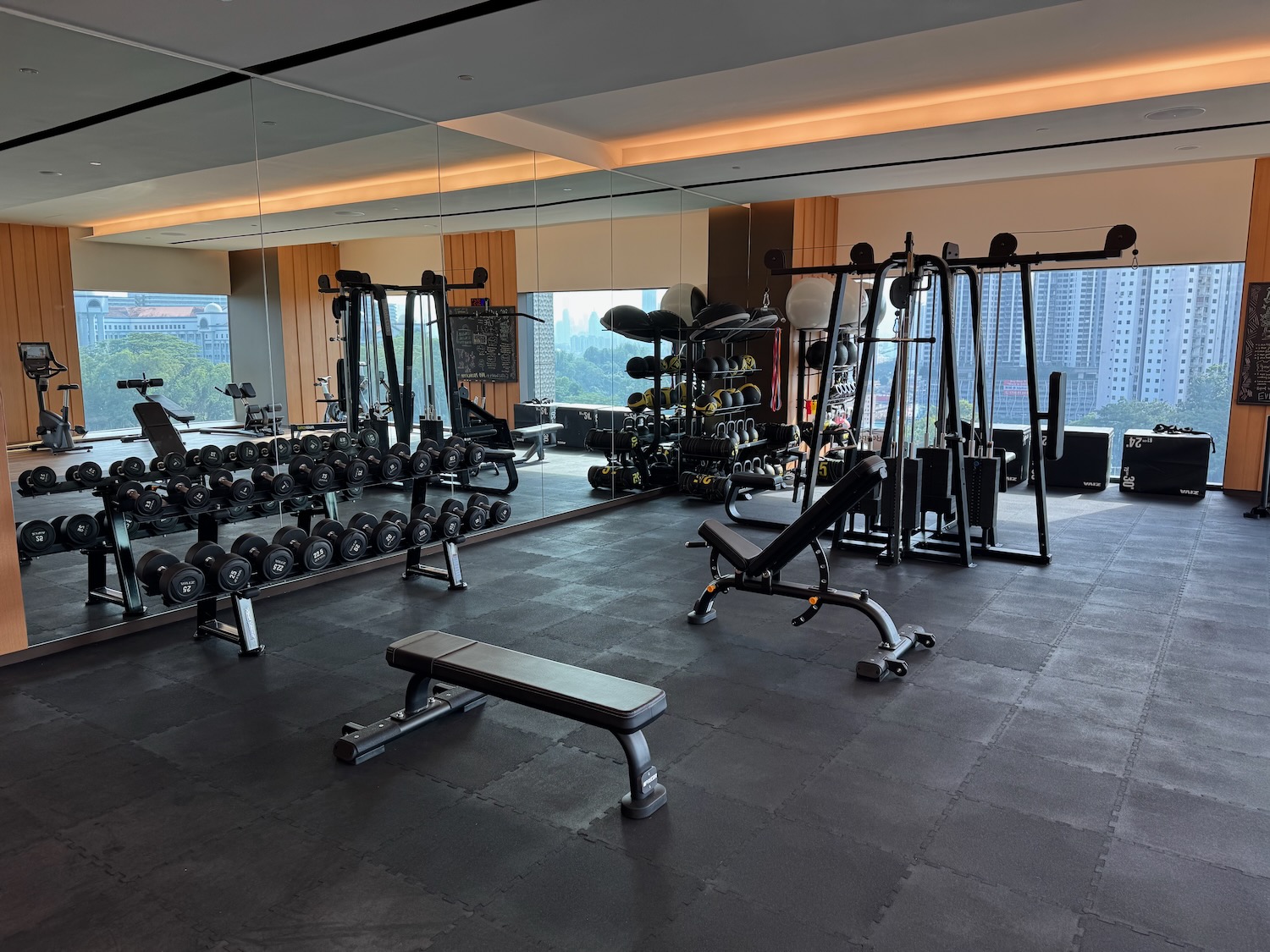a large room with weights and a mirror