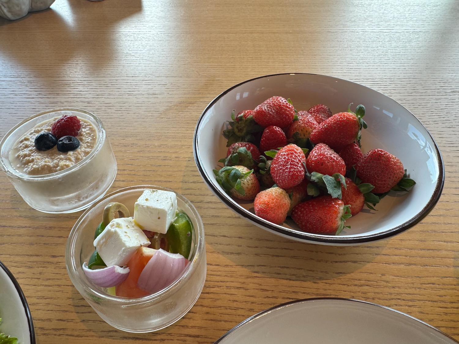 a bowl of strawberries and a bowl of fruit