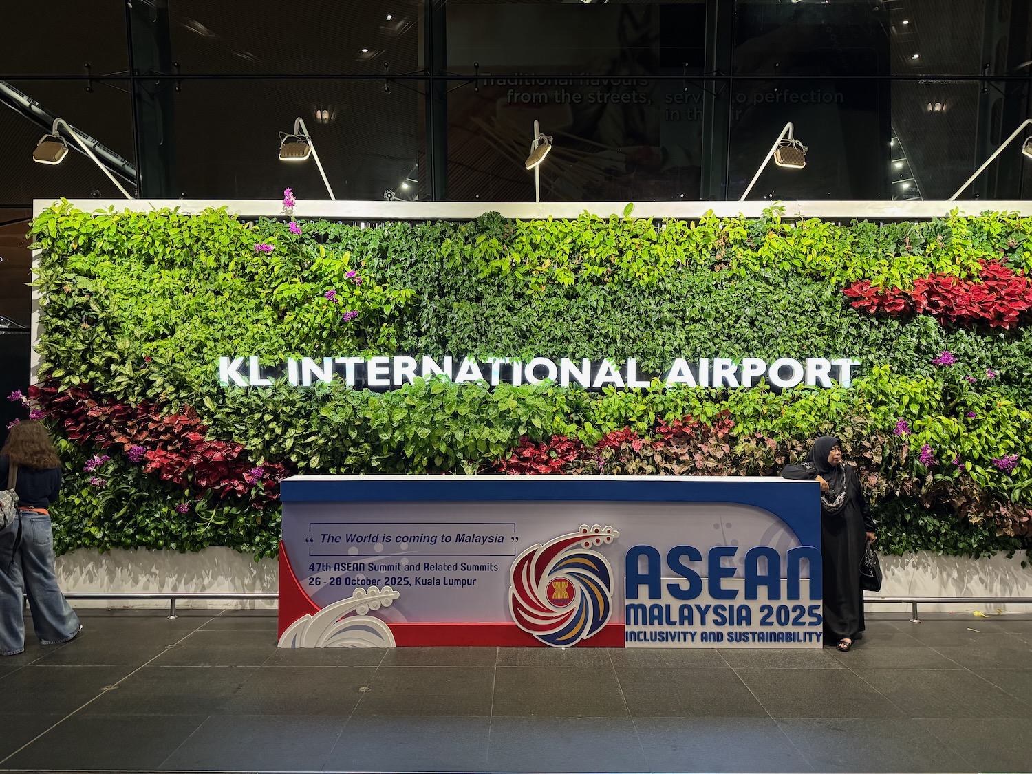 a sign with plants on the wall