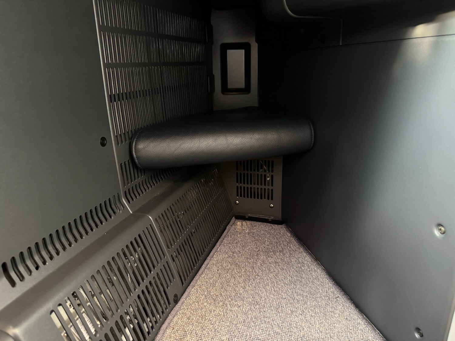 a black object with a seat and a carpet