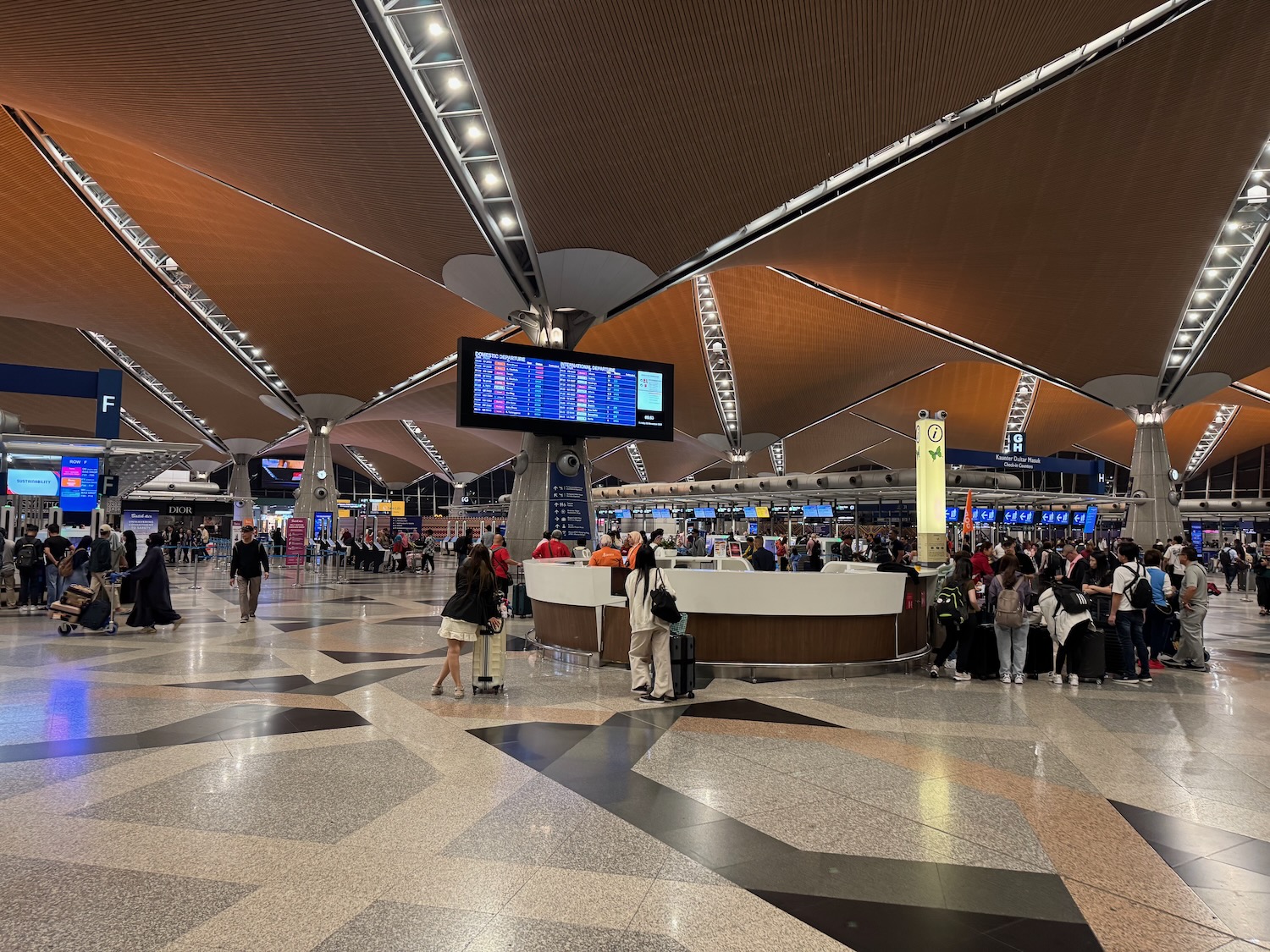 a group of people in a large airport terminal