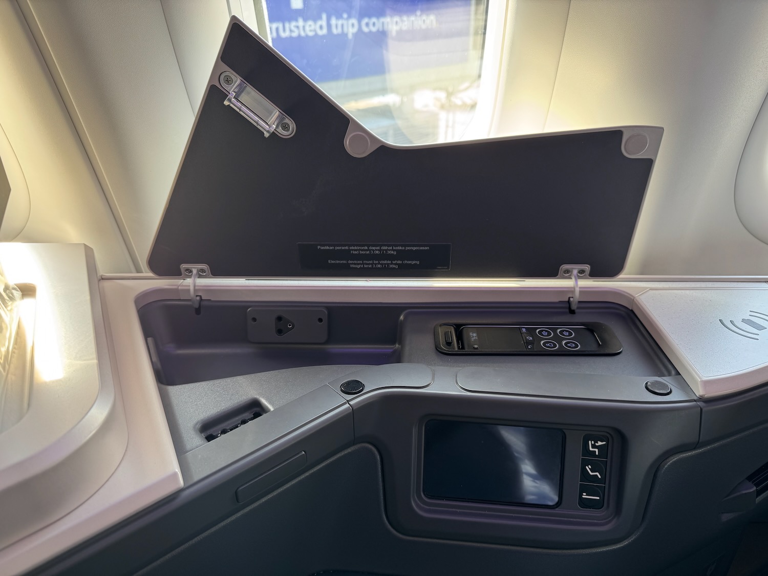 an empty seat with a phone and a screen