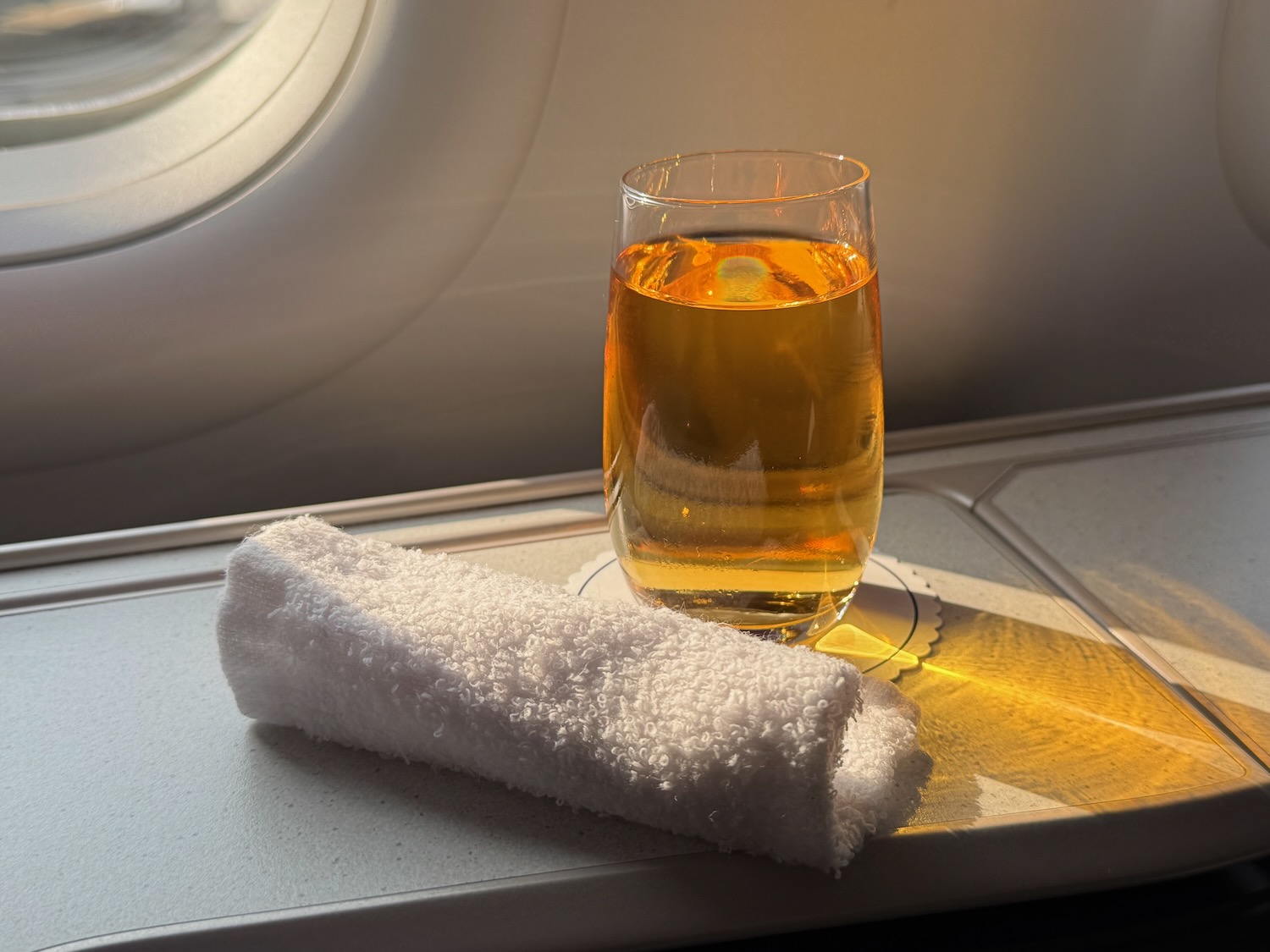a glass of liquid and a towel on a table