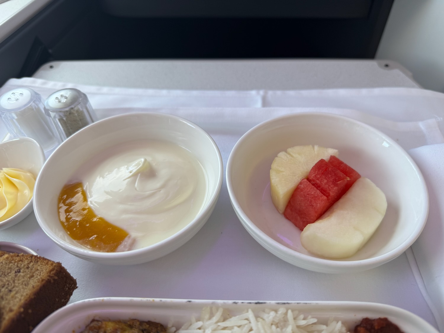 a bowl of yogurt and fruit in a tray