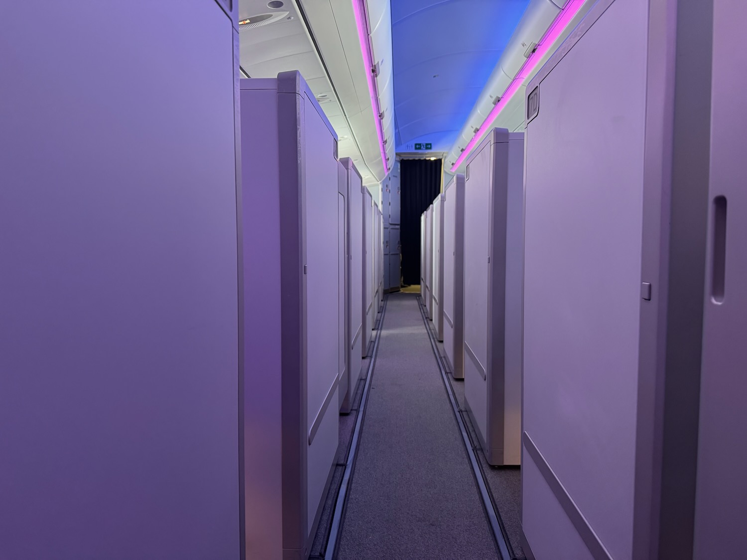 a long hallway with white cabinets