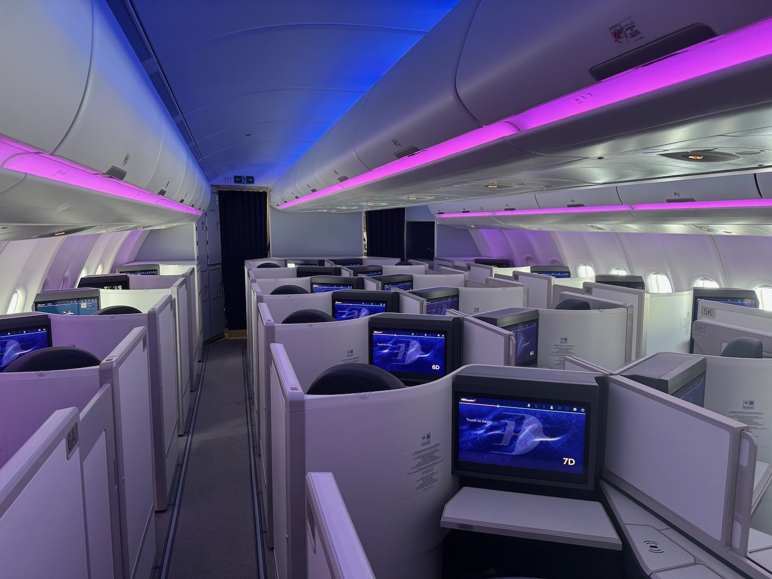 a row of seats with monitors on the side