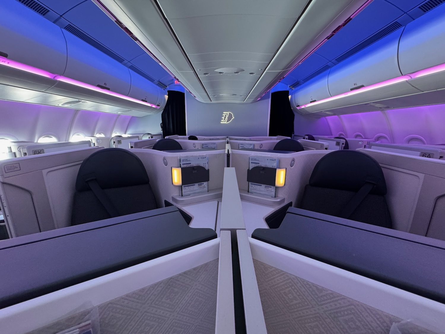 inside a plane with seats and lights