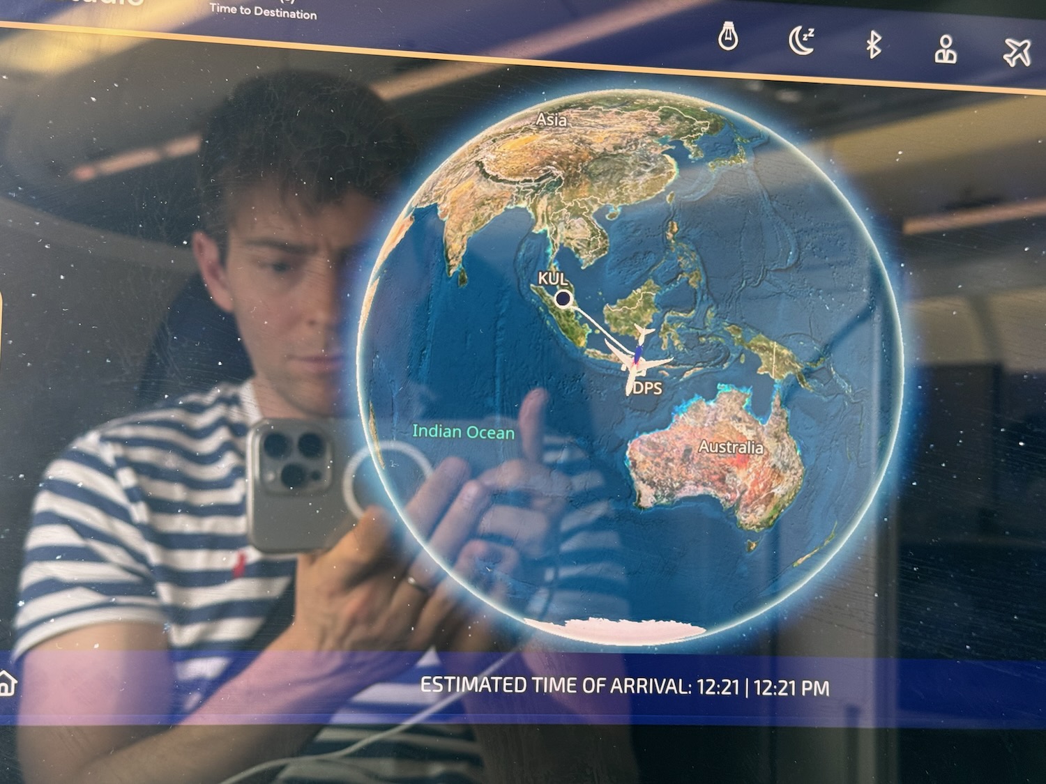 a man taking a picture of a planet earth
