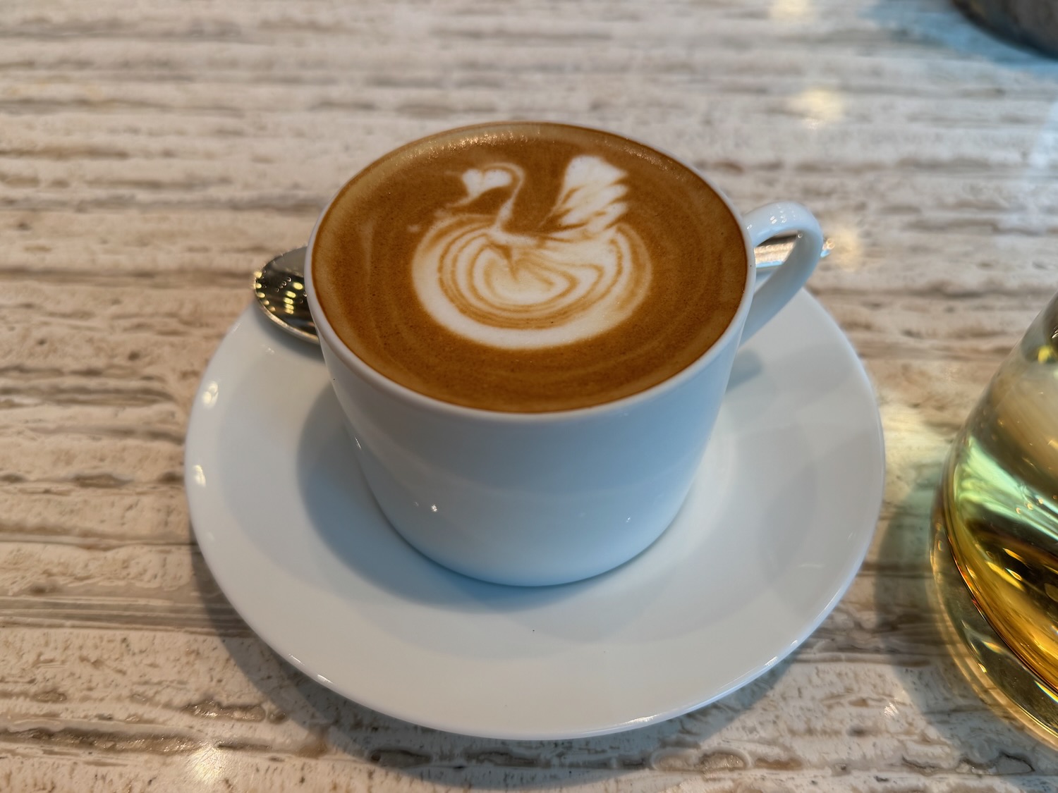 a cup of coffee with a swan design on top