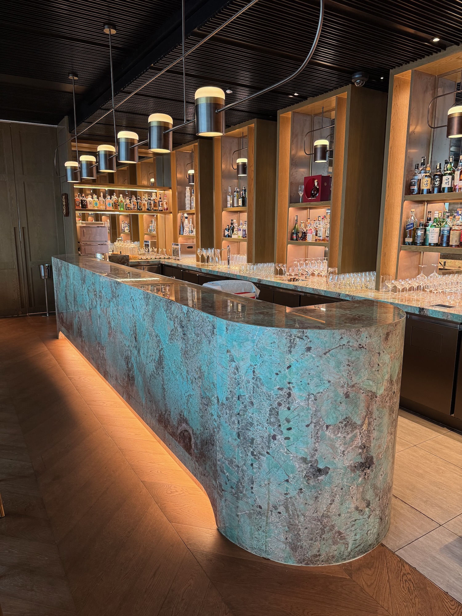 a bar with a counter and bottles of liquor