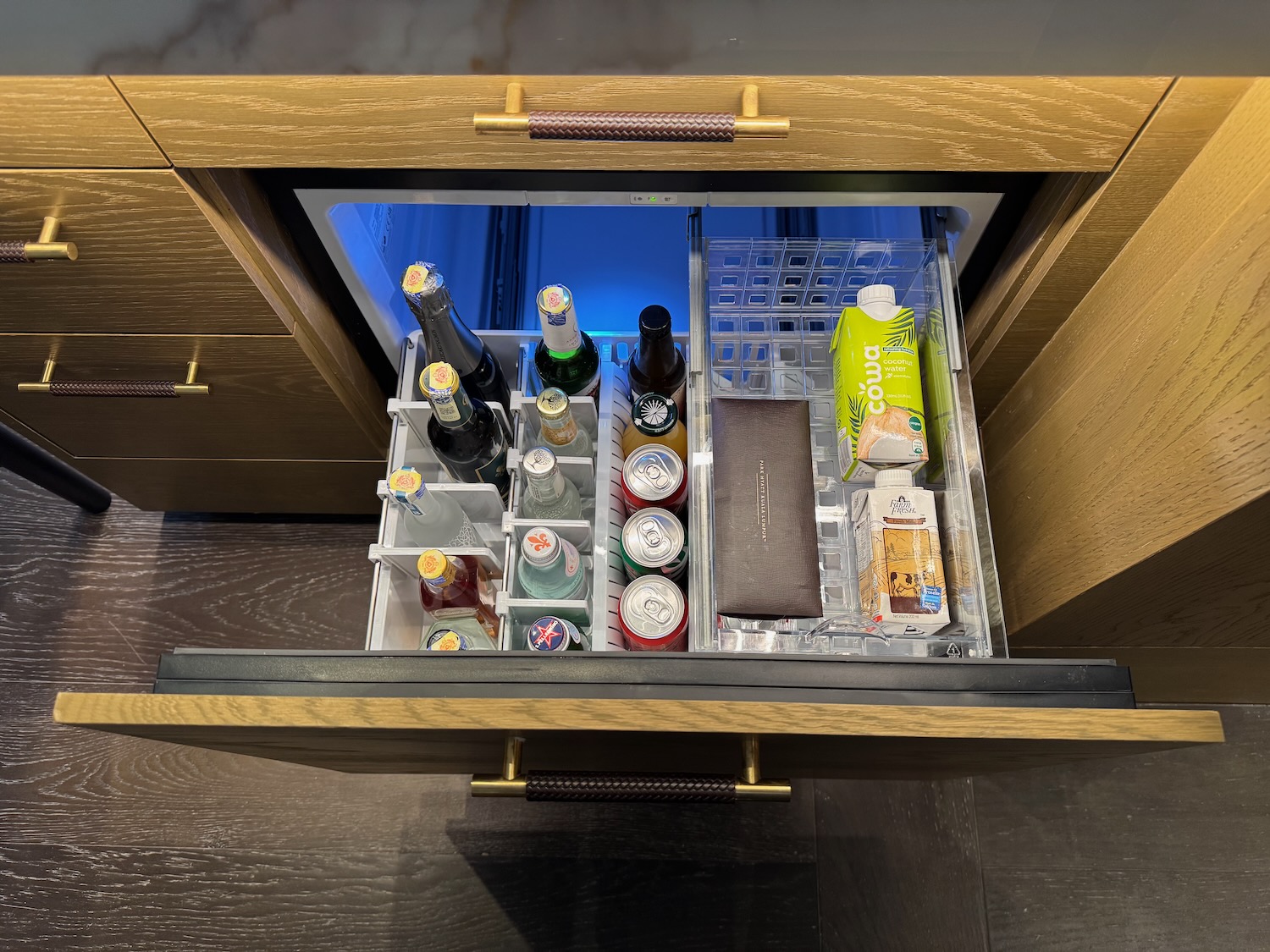 a small refrigerator with drinks and beverages inside