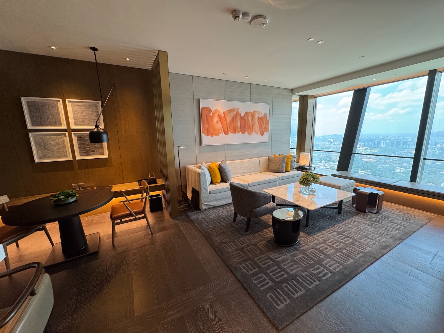 a room with a large window and a couch and a table