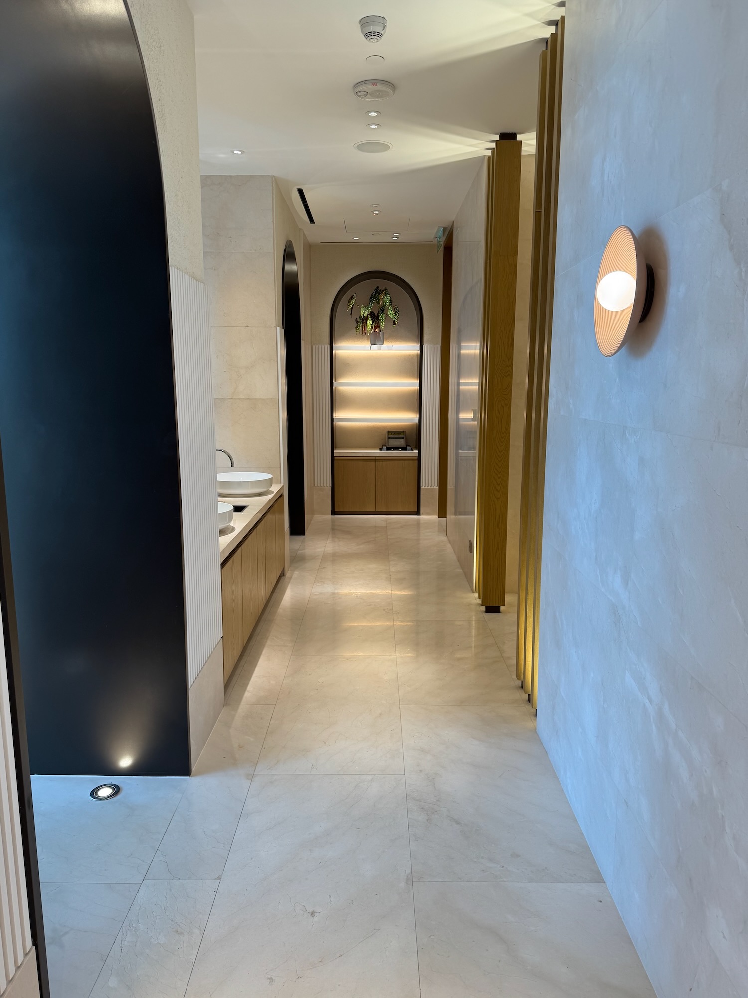 a hallway with a sink and a mirror