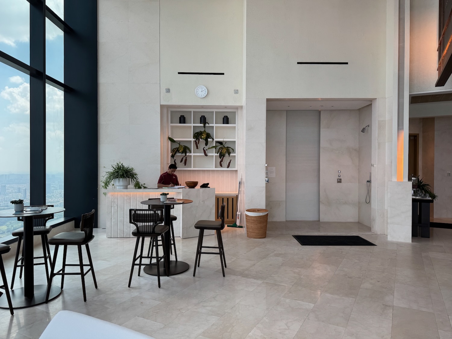 a white room with a counter and chairs