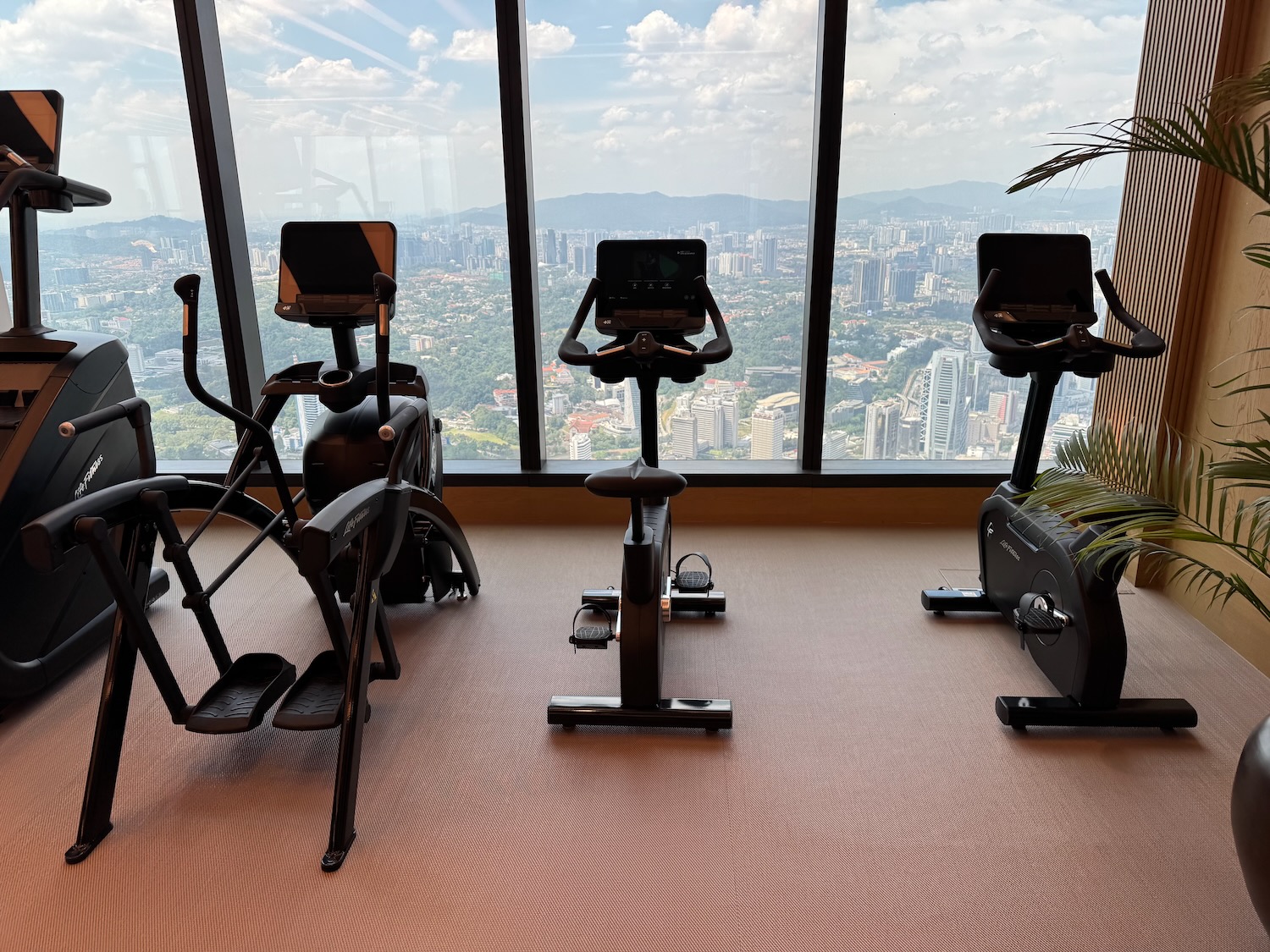 a room with exercise bikes and a view of a city